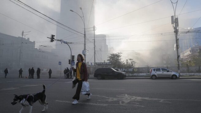 A woman walks her dog after an explosion in Kyiv (Ukraine).
