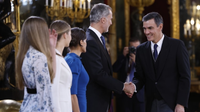 Kings Felipe and Letizia, Princess Leonor and Infanta Sofia greet Prime Minister Pedro Sánchez during the welcoming of guests in the throne room of the Royal Palace after the ceremony of putting on the collar of Charles III and before lunch.  this takes place in the formal dining room of the Royal Palace after the oath of office of the Princess of Asturias.