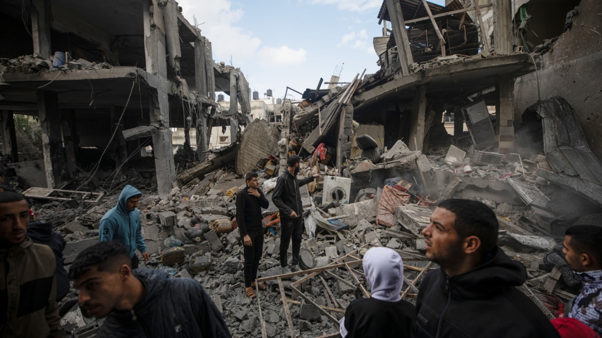 Los palestinos inspeccionan los escombros de una estructura destruida tras los ataques aéreos israelíes en la ciudad de Rafah, en el sur de la Franja de Gaza