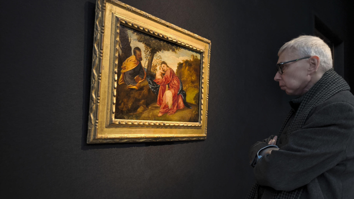 Un hombre observa la obra "Descanso en la huida a Egipto" de Tiziano