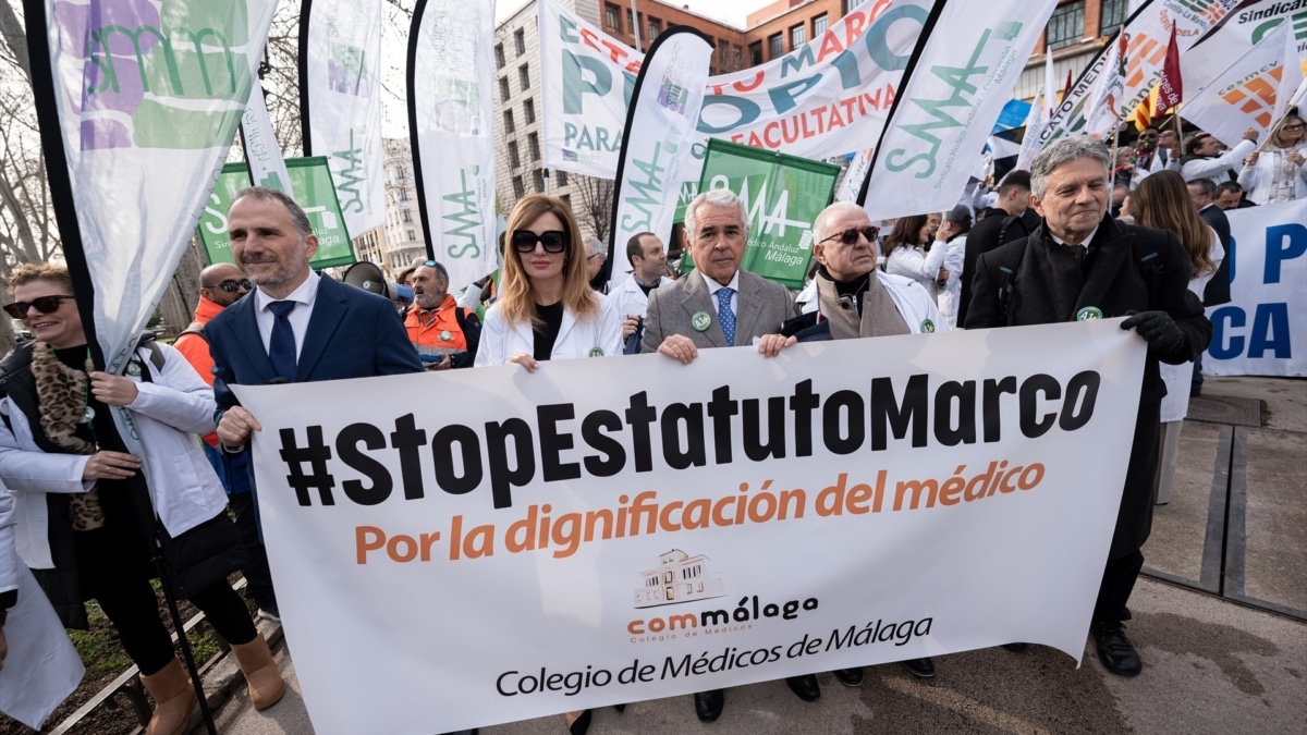 Varias personas sujetan una pancarta durante una concentración de los sindicatos médicos frente al Ministerio de Sanidad